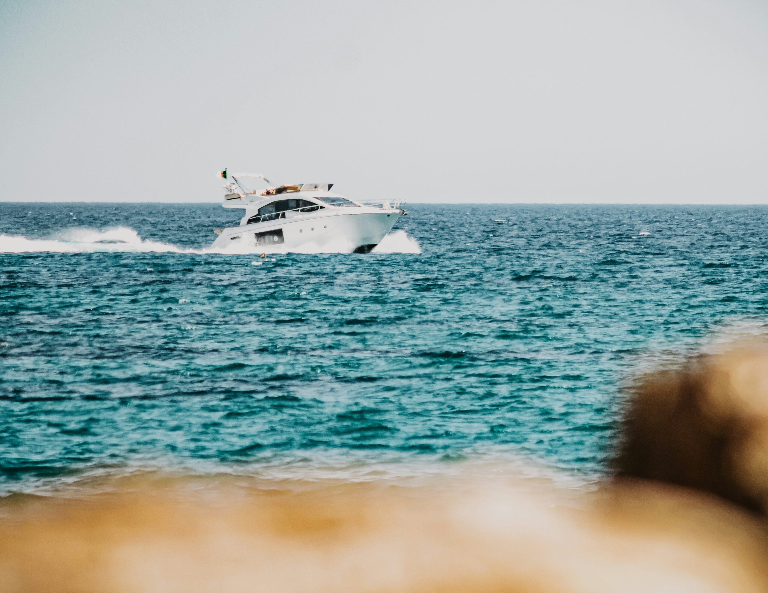 white and black boat on sea during daytime